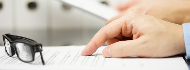 Close up of a hand pointing to a document